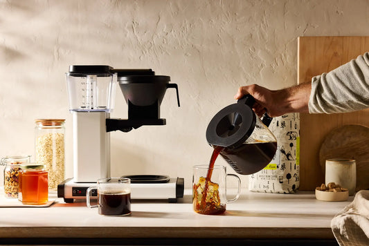 Man pouring Mt Comfort Coffee into cup at home coffee bar