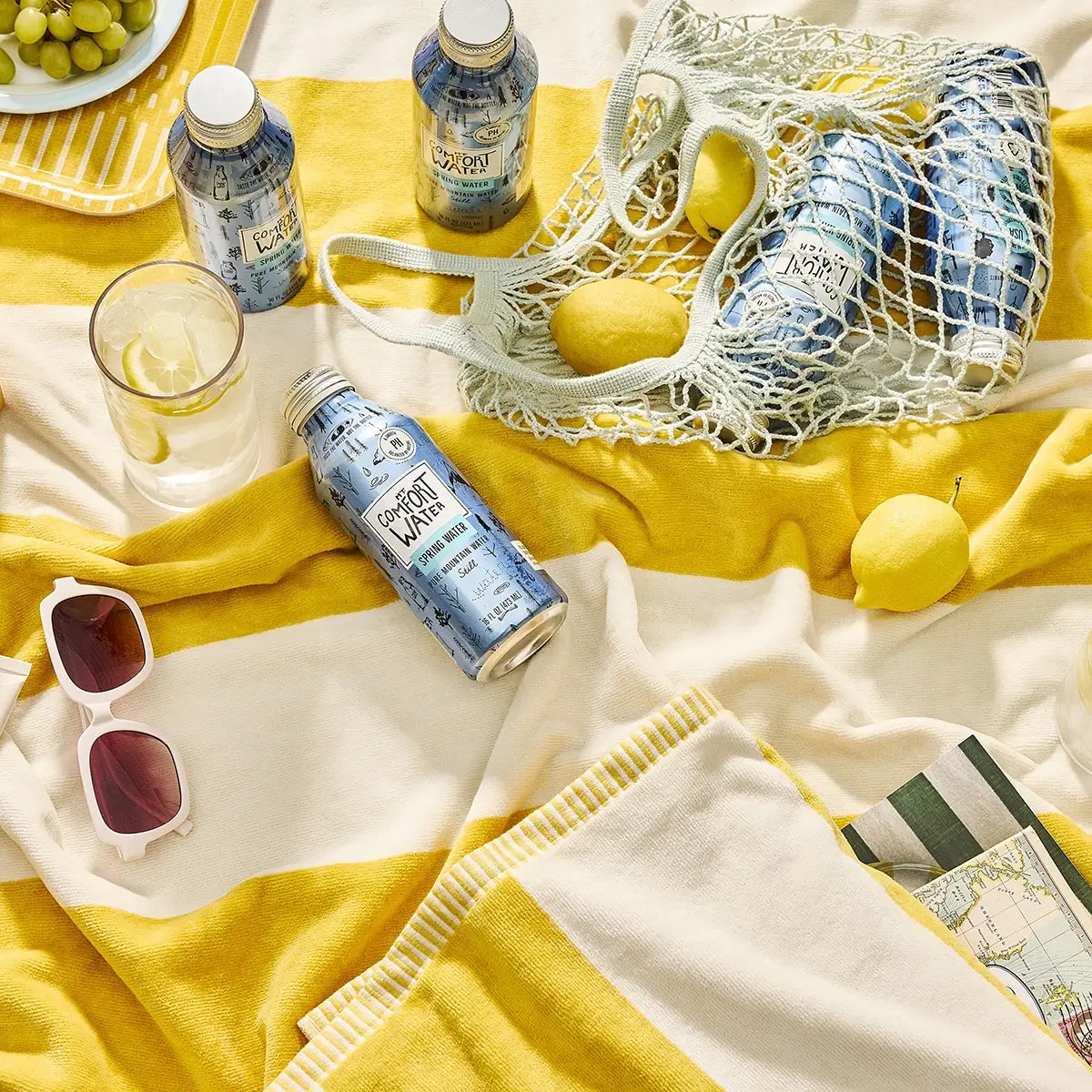 Mt. Comfort Water - aluminum bottled water on beach towel