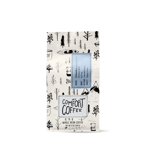 Packaging of Mt Comfort Colombian Coffee, Full City Roast, featuring a black and white design with coffee illustrations.