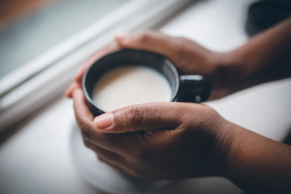 hand holding coffee wholesale from Mt Comfort