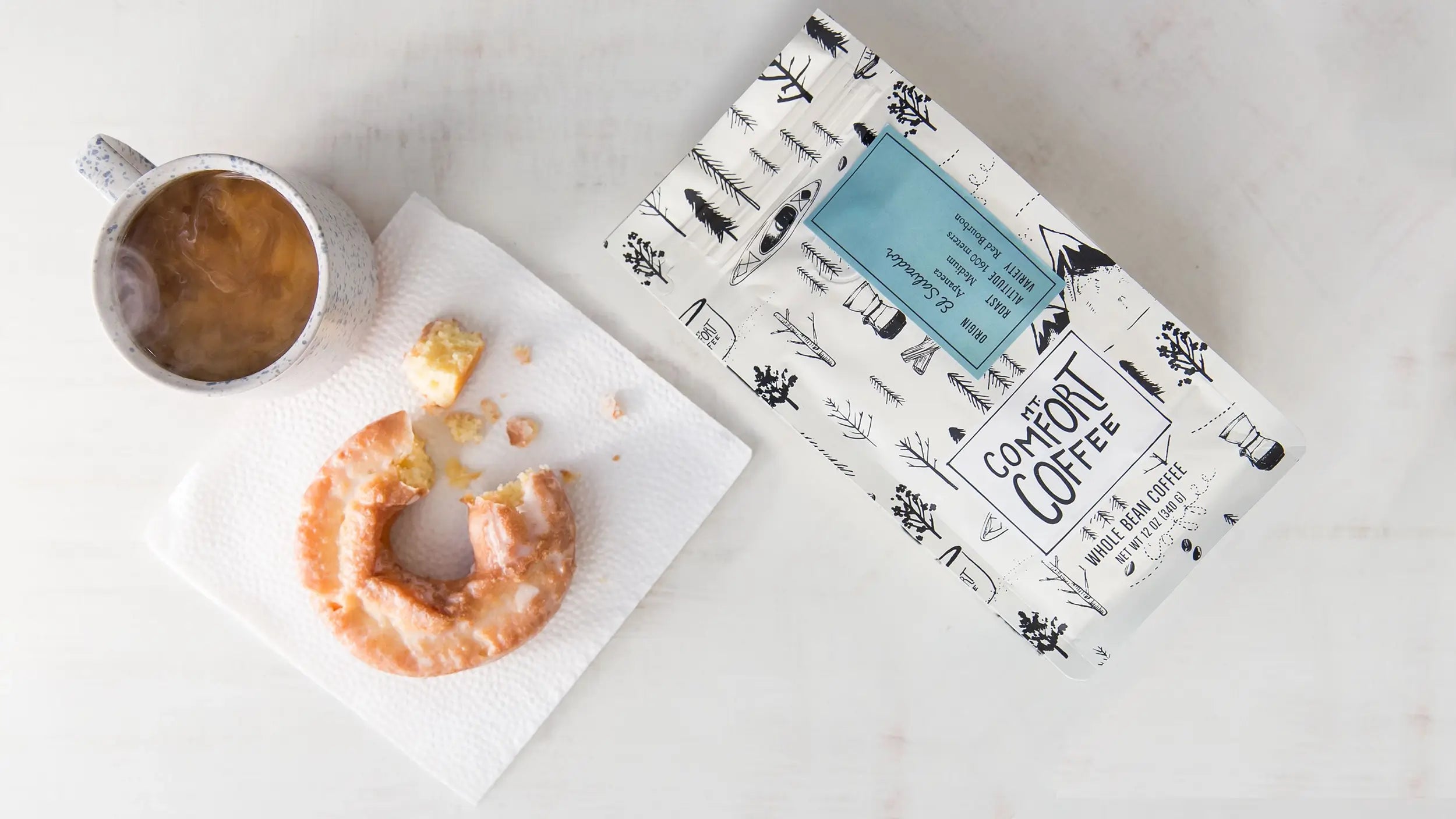 Cup of Mt Comfort coffee with package for coffee subscription promo 10% off